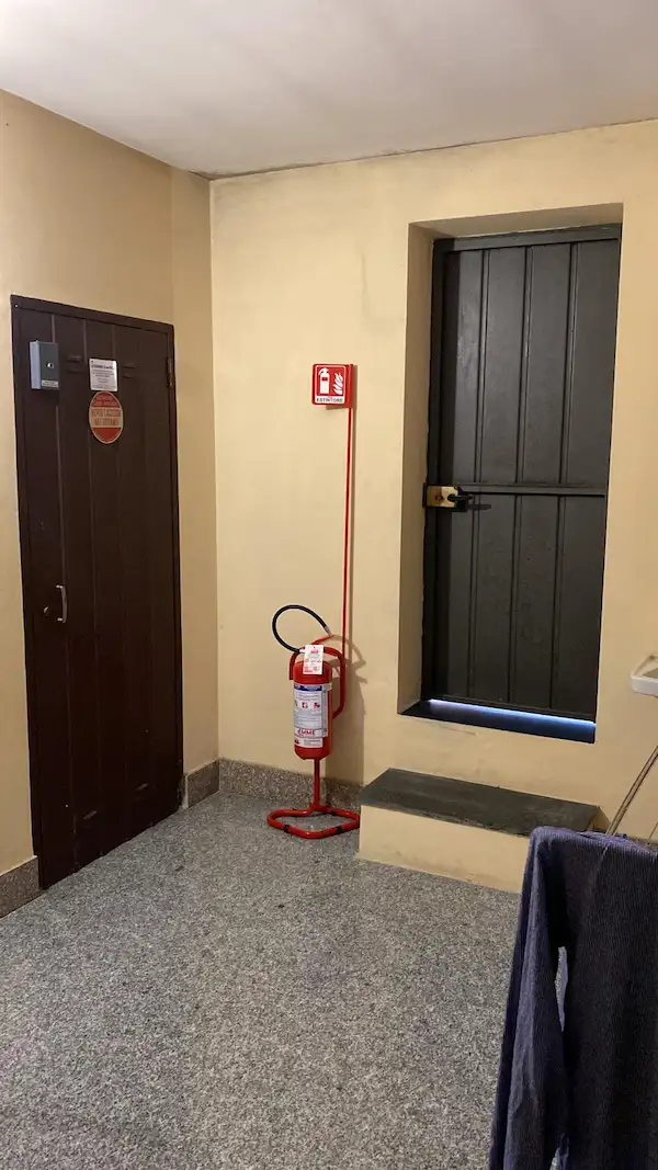 Estintore su piantana nell'androne di un condominio